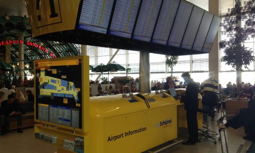 SCHIPHOL Informatie Balie, Altijd herkenbaar. Super hoogglans gele epoxy. Interieurbouw Intos.